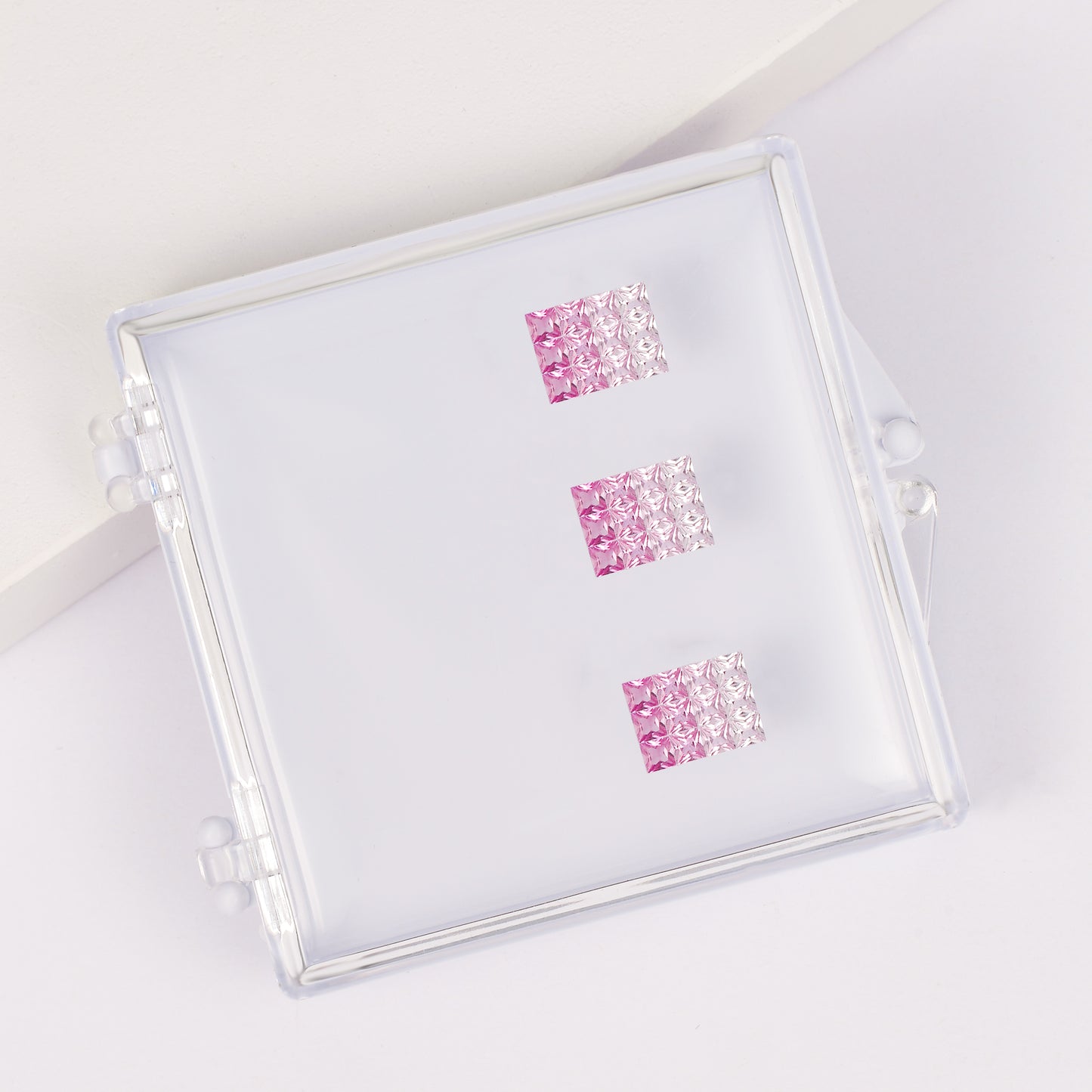 Princess-cut pink and blue sapphire gradient pendant set in a gemstone box.