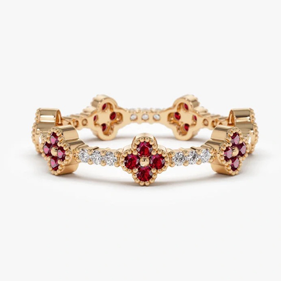 Four-leaf clover ring set with round sapphire stones in a box