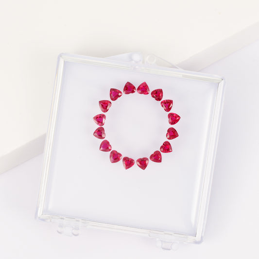 Heart-shaped ruby bracelet set in a gemstone box.