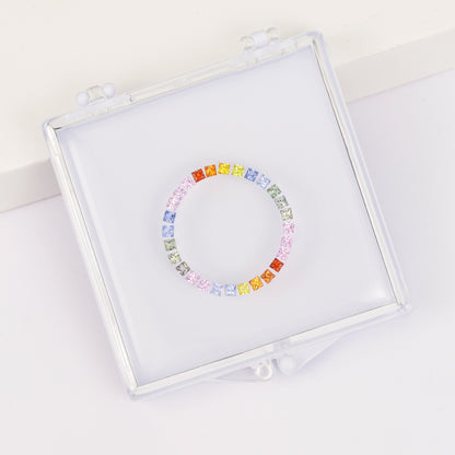 Princess cut sapphire ring set in a gemstone box.