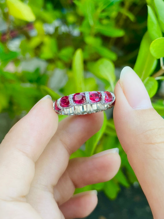 Ruby and diamond eternity ring in 18K white gold.